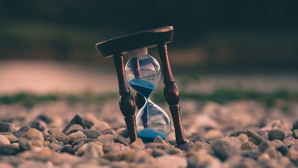 Hour glass on pebbles to represent time ticking away