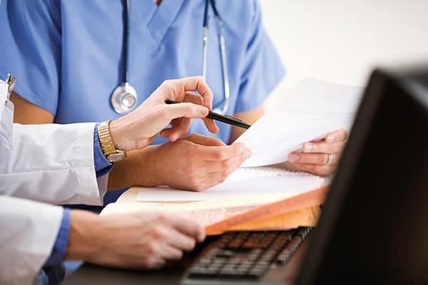 health professionals meeting and looking at documents