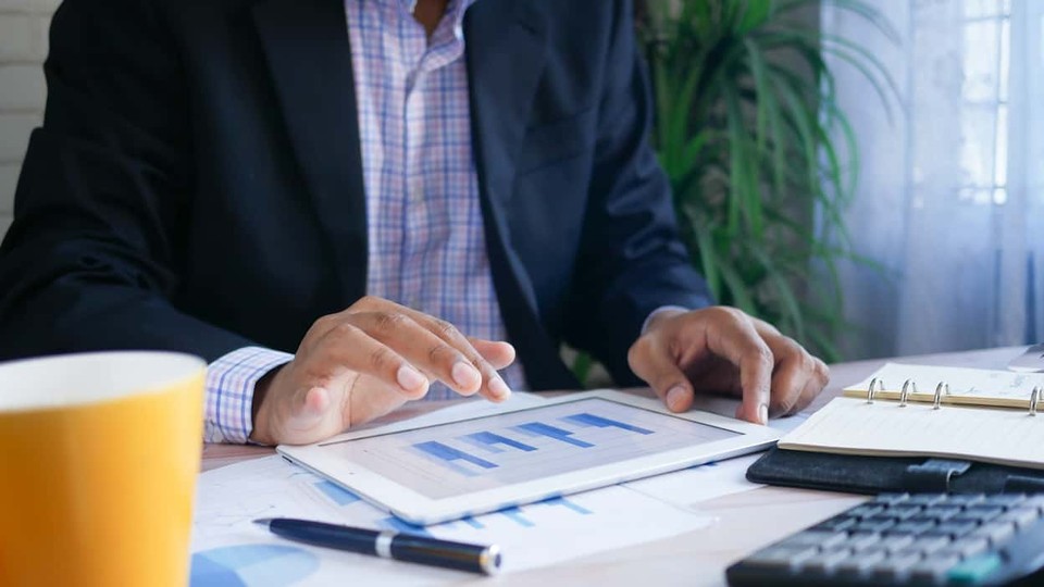 Manager reviewing mission-critical financial services options on a tablet device